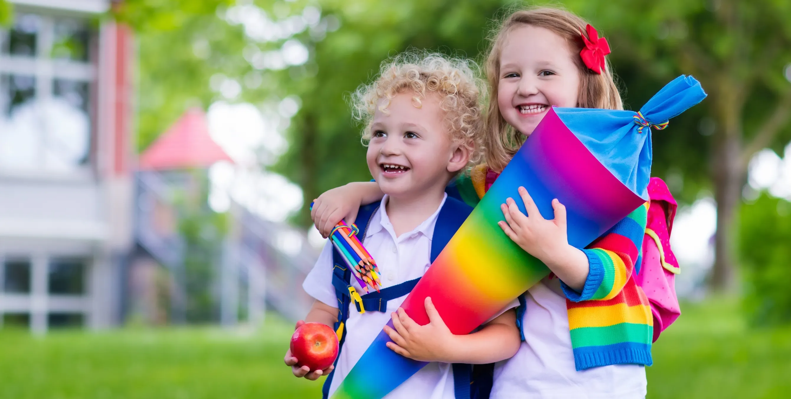 Zwei strahlende Kinder mit einer bunten Schultüte