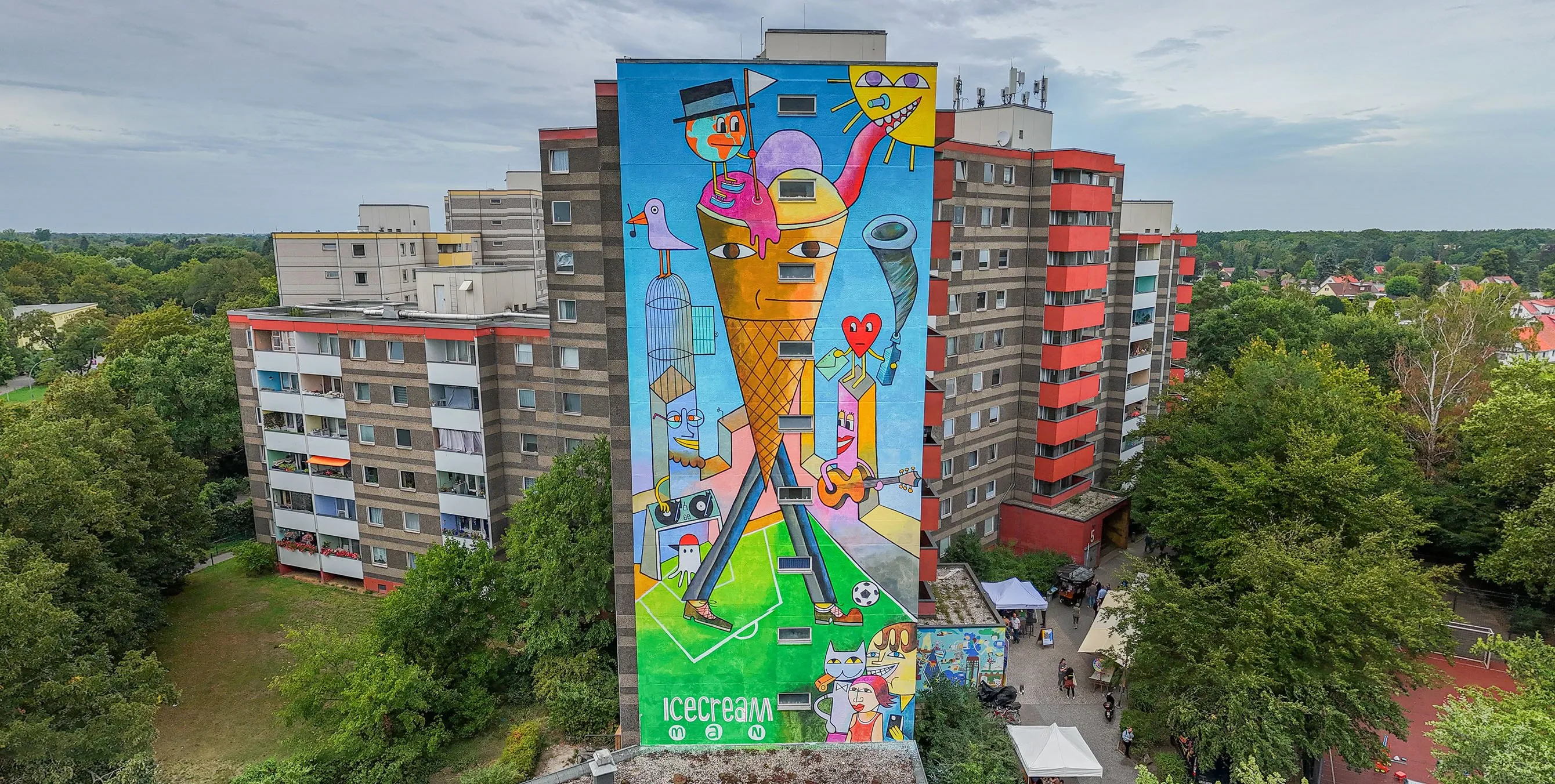 Drohnenaufnahme: eine große, bunt bemalte Häuserfassade an einem Hochhaus. Foto: Felix Seyfert
